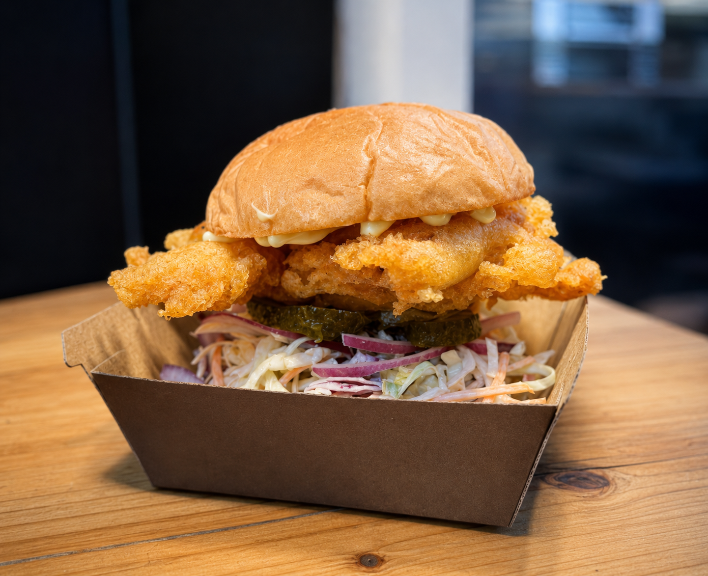 Soft shell crab burger with slaw, pickles and red onion